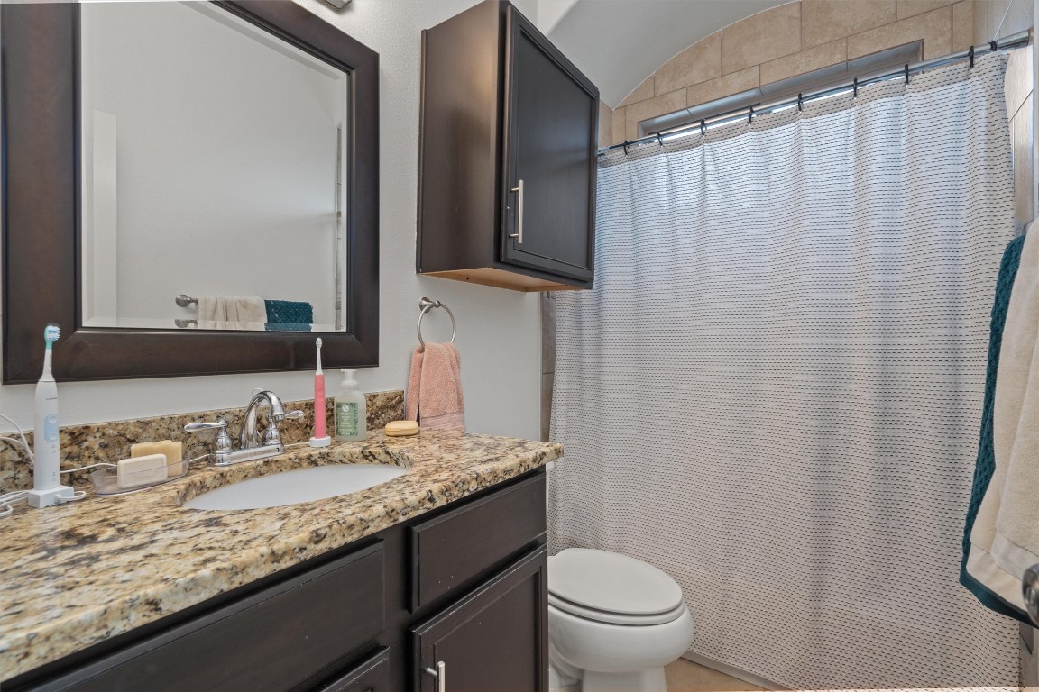 500 West 55th 1/2 Street, Unit A AND B Austin, TX 78751 - Photo 12 of 32 a bathroom with a granite countertop sink and a mirror