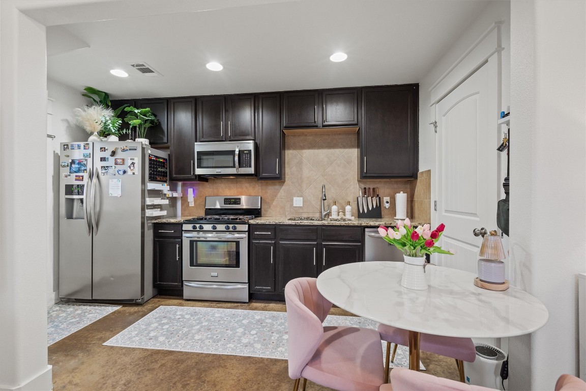 500 West 55th 1/2 Street, Unit A AND B Austin, TX 78751 - Photo 21 of 32 a kitchen with stainless steel appliances granite countertop a sink stove and refrigerator