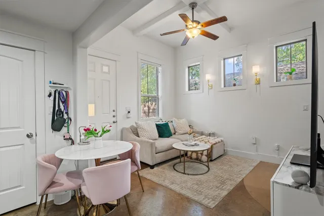 a living room with furniture a window and a chandelier