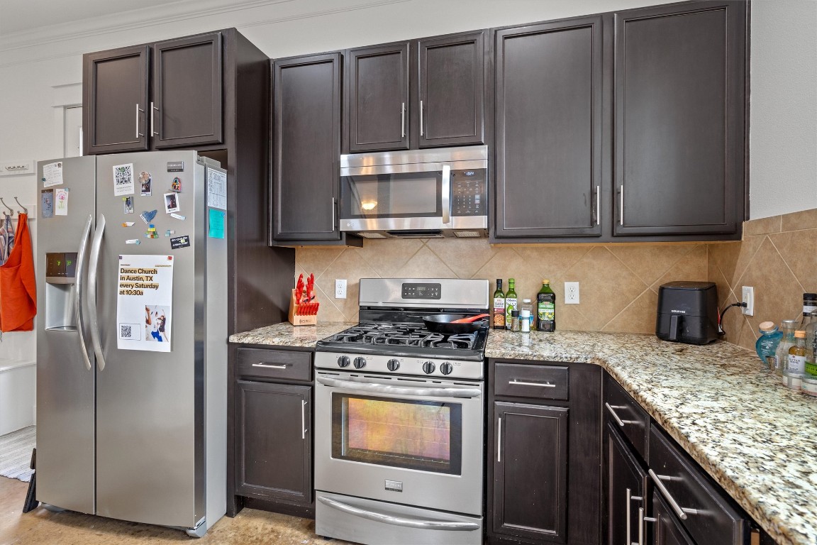 500 West 55th 1/2 Street, Unit A AND B Austin, TX 78751 - Photo 7 of 32 a kitchen with stainless steel appliances granite countertop a refrigerator stove and microwave