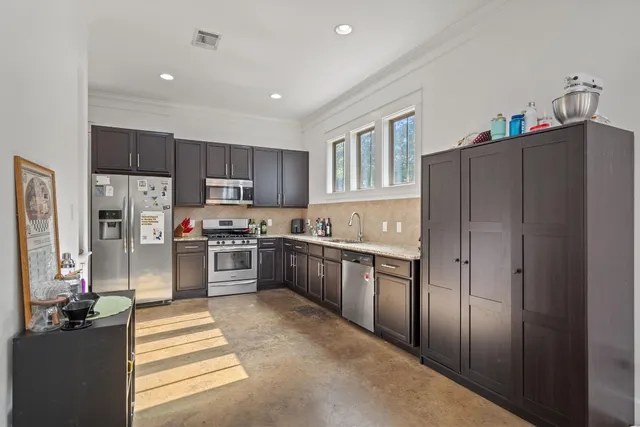 a large kitchen with cabinets and stainless steel appliances