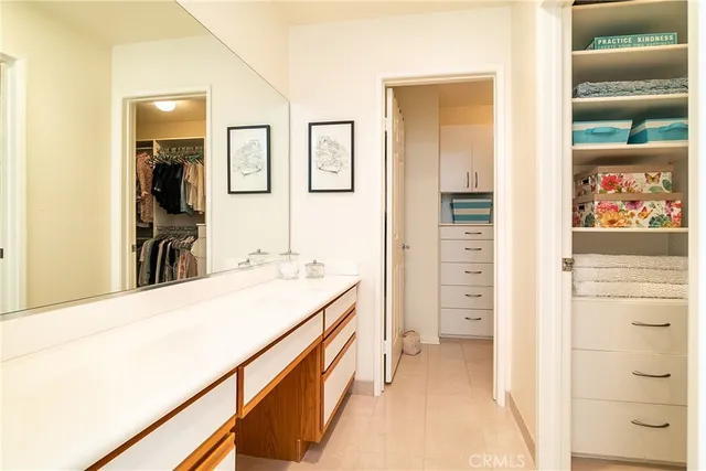 a view of a hallway with a kitchen and a refrigerator