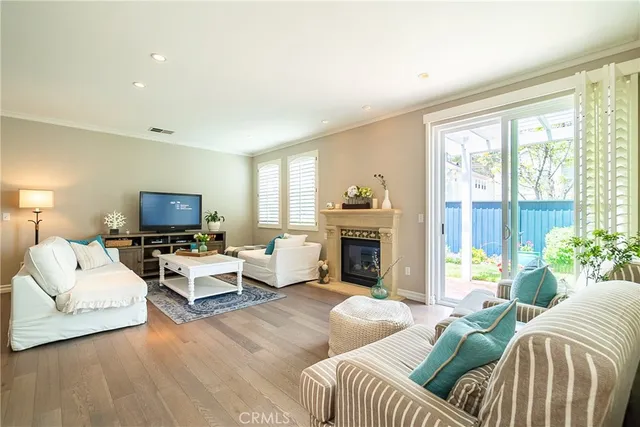 a living room with furniture fireplace and a large window