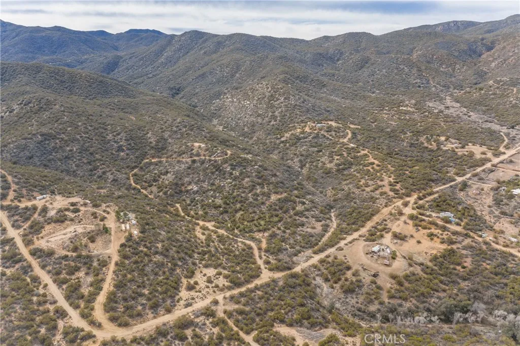 69 Rim Rock Road Anza, CA 92539 - Photo 14 of 14 a view of a dry yard with mountains in the background