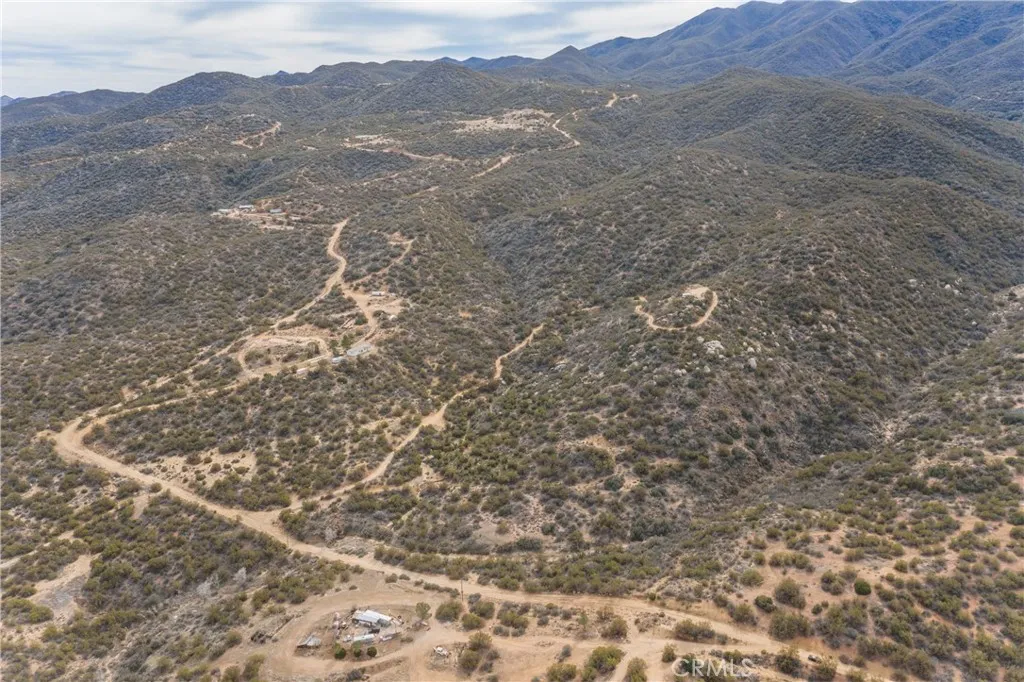 69 Rim Rock Road Anza, CA 92539 - Photo 6 of 14 a view of a dry yard with mountains in the background