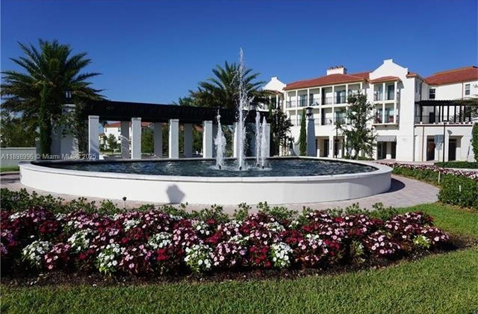 17154 Southwest 93rd Street, Unit STUDIO Miami, FL 33196 - Photo 2 of 9 a front view of a house with a garden