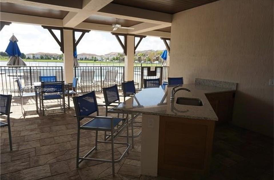 17154 Southwest 93rd Street, Unit STUDIO Miami, FL 33196 - Photo 7 of 9 a view of a dining room with furniture large windows and wooden floor