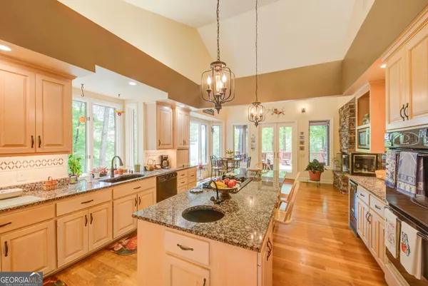 an outdoor space with seating area and trees in the background