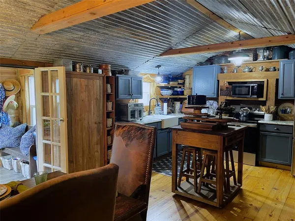 a view of house with yard outdoor seating and barbeque oven