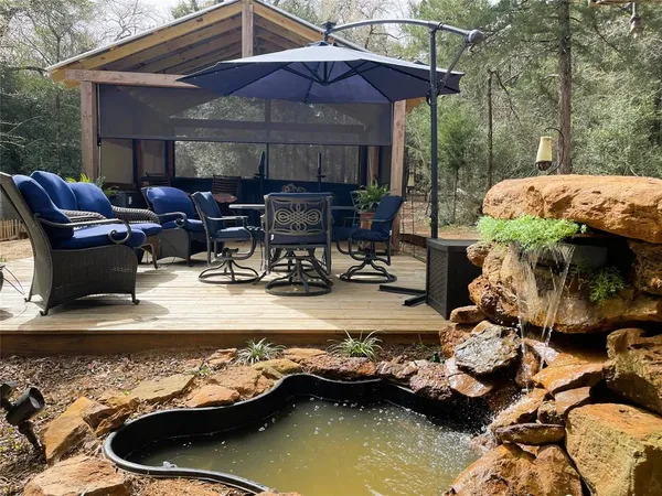a view of a house with swimming pool and sitting area