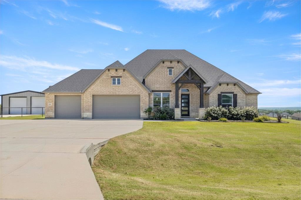 305 Monument Place Azle, TX 76020 - Photo 1 of 40 a front view of a house with yard