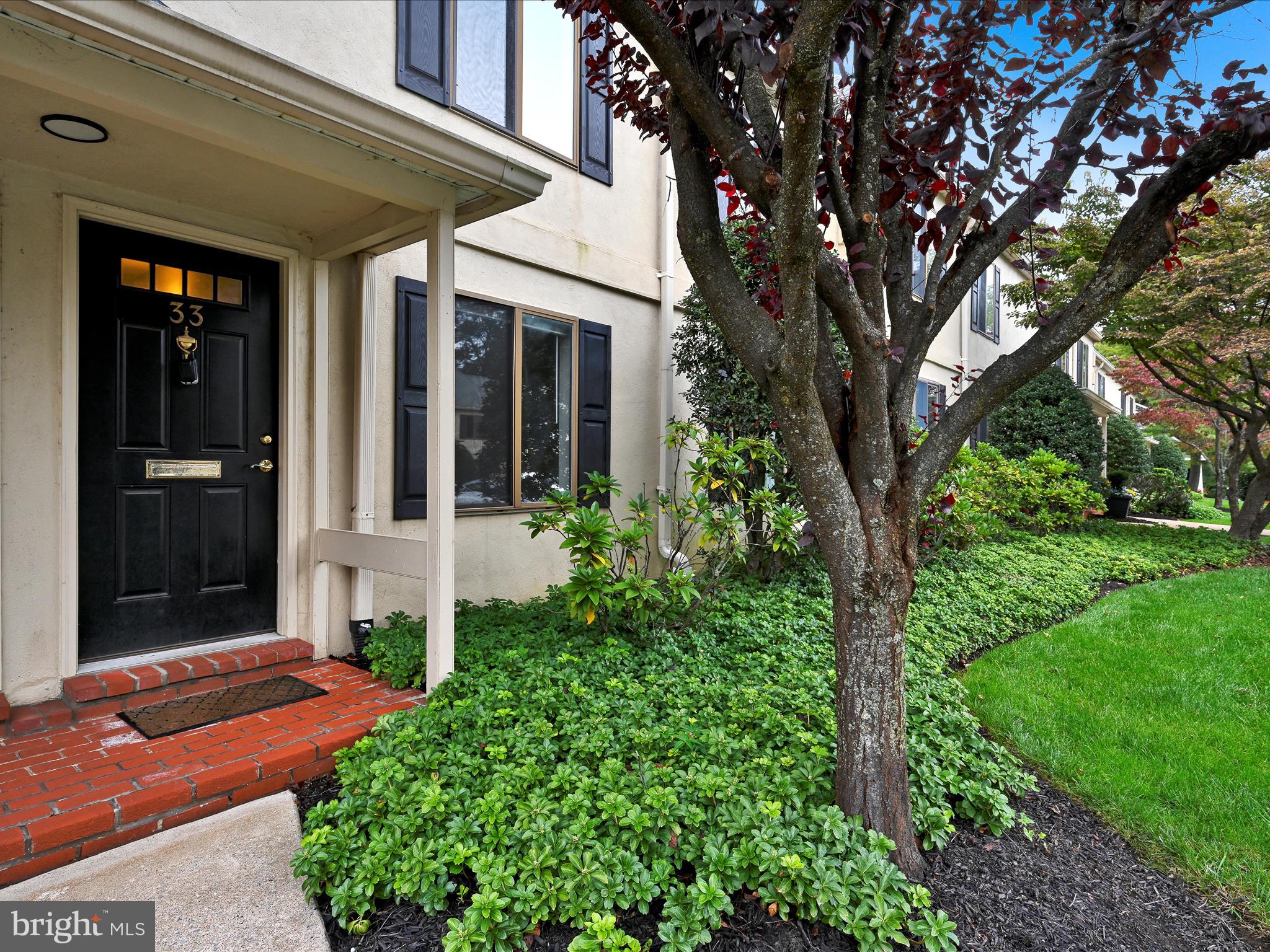 411 Conestoga Road, Unit 33 Devon, PA 19333 - Photo 2 of 23 front view of a house with a yard