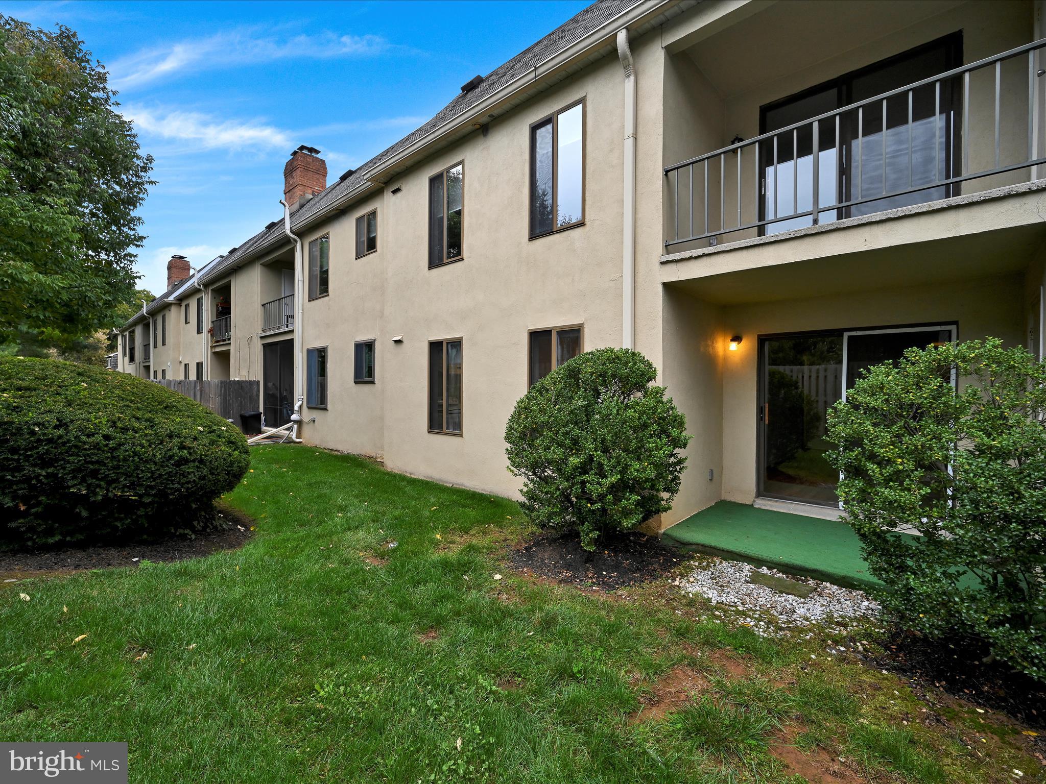 411 Conestoga Road, Unit 33 Devon, PA 19333 - Photo 21 of 23 a front view of a house with a garden and plants
