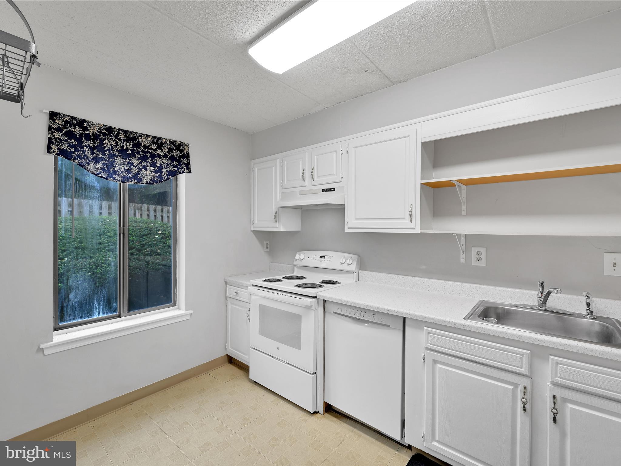 411 Conestoga Road, Unit 33 Devon, PA 19333 - Photo 9 of 23 a kitchen with appliances cabinets and a sink