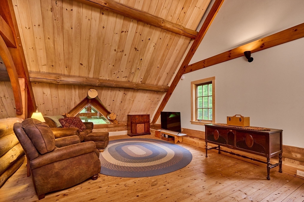 486 Old Stage Road Ashfield, MA 01330 - Photo 21 of 36 a living room with furniture a rug and a window