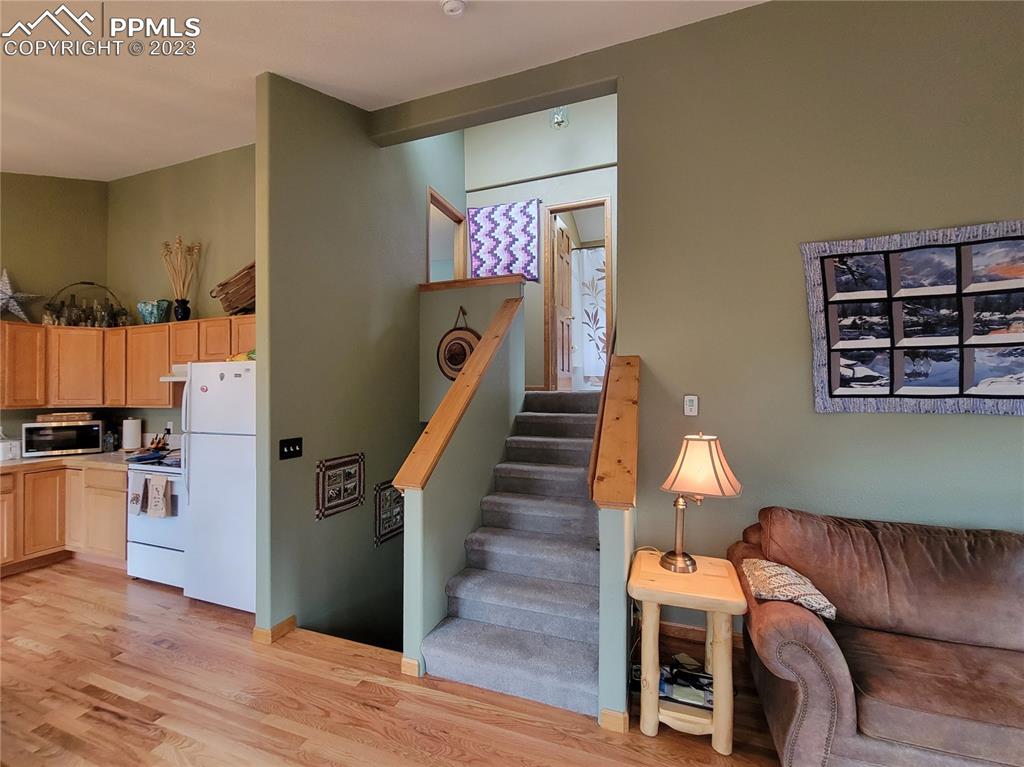 33348 Persistence Avenue Pine, CO 80470 - Photo 18 of 39 a view of a kitchen with furniture and wooden floor