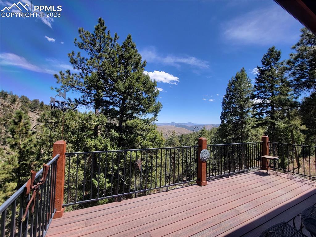 33348 Persistence Avenue Pine, CO 80470 - Photo 33 of 39 a view of a balcony with wooden floor and city view