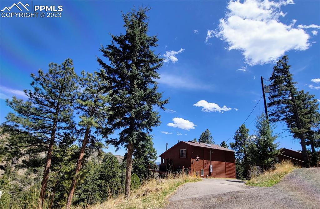 33348 Persistence Avenue Pine, CO 80470 - Photo 37 of 39 a front view of a house with a yard