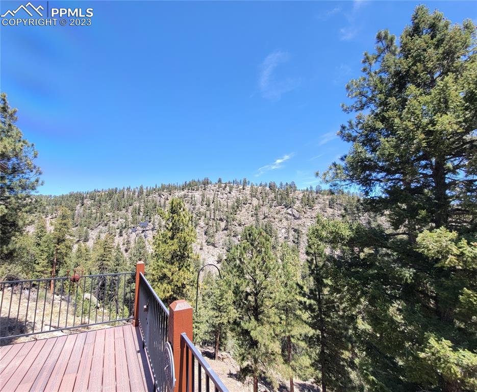 33348 Persistence Avenue Pine, CO 80470 - Photo 6 of 39 a view of a balcony with wooden floor and city view