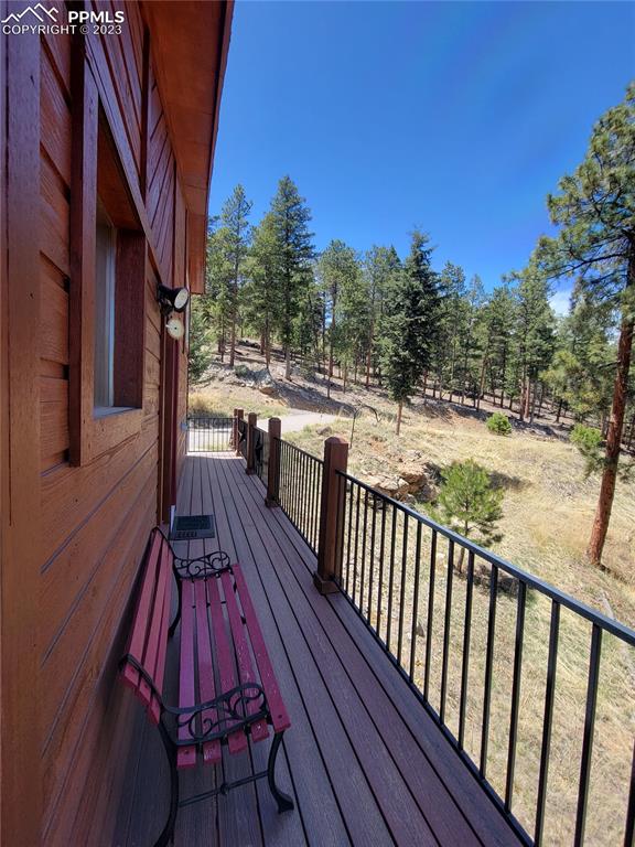 33348 Persistence Avenue Pine, CO 80470 - Photo 7 of 39 a view of balcony with wooden floor and fence