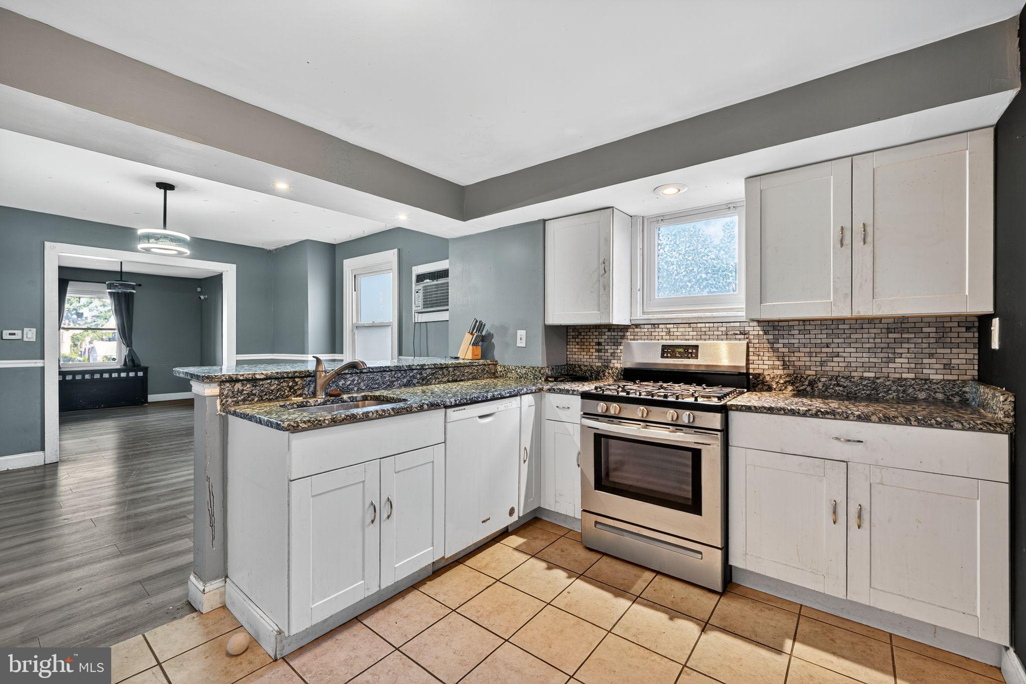 82 Marple Avenue Clifton Heights, PA 19018 - Photo 14 of 30 a kitchen with stainless steel appliances granite countertop a stove and a sink