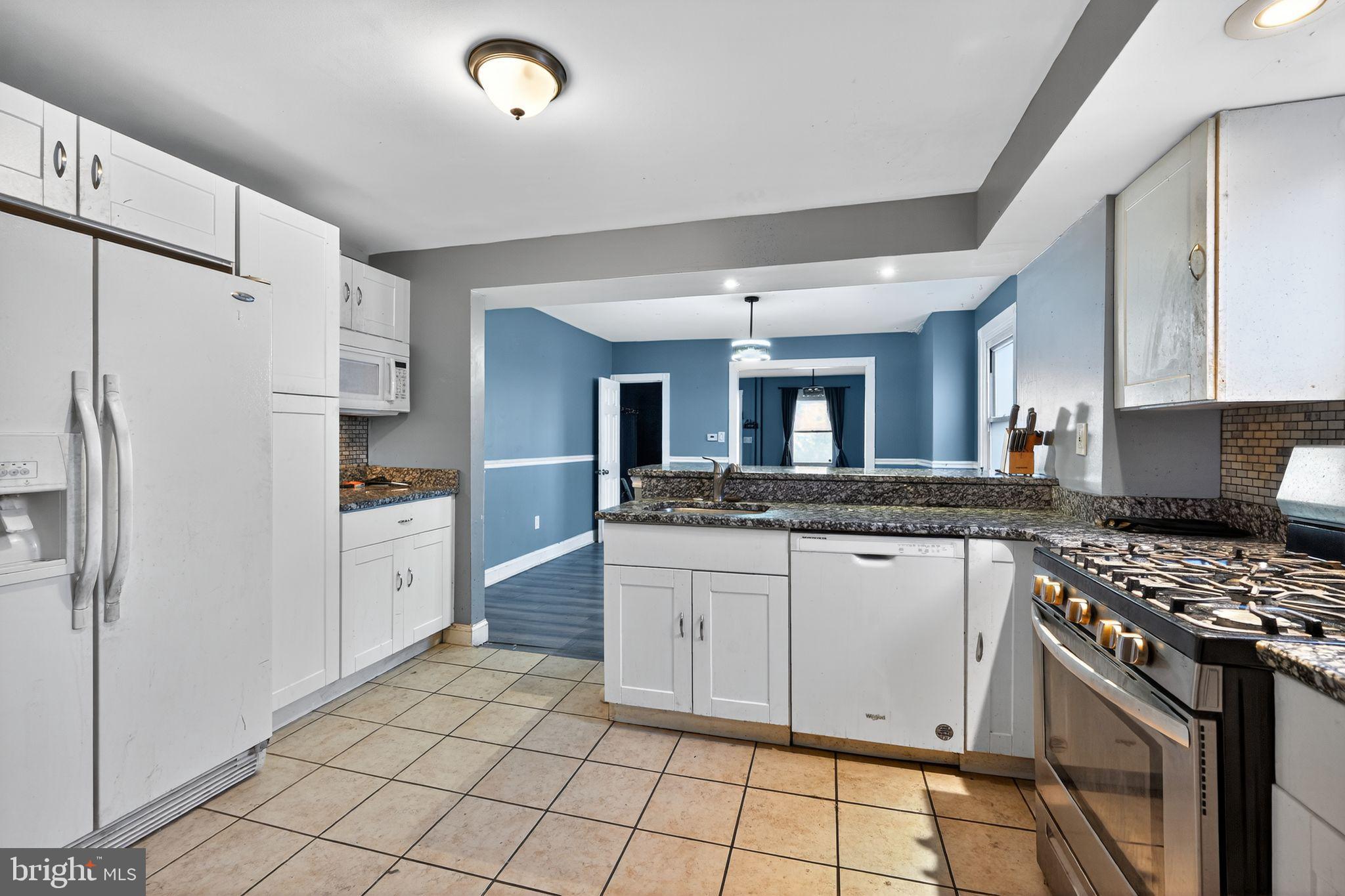 82 Marple Avenue Clifton Heights, PA 19018 - Photo 15 of 30 a kitchen with granite countertop a sink stove and refrigerator