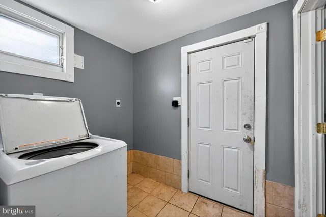 a living room with a stove and a window