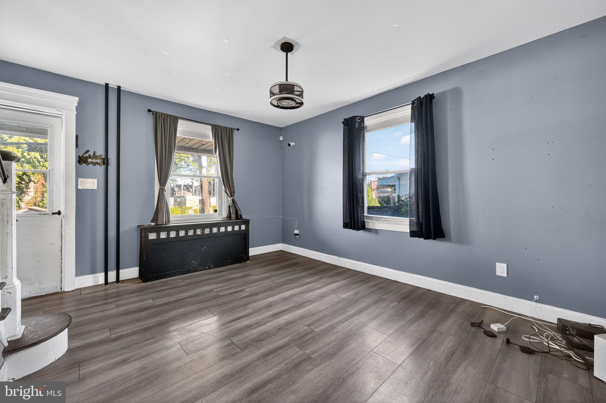 82 Marple Avenue Clifton Heights, PA 19018 - Photo 8 of 30 a view of an empty room and window and wooden floor