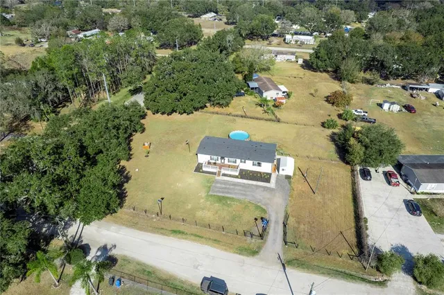 an aerial view of a house with a swimming pool