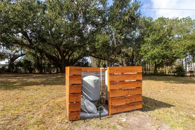 a view of a house with backyard and sitting area