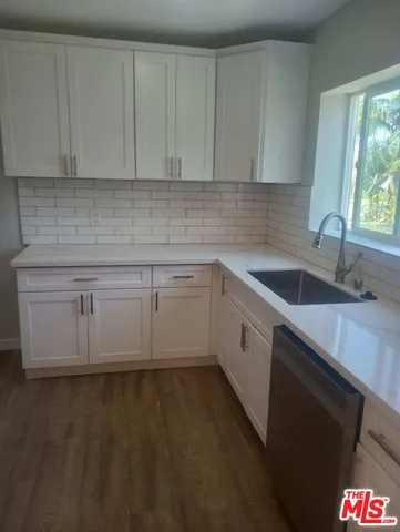 a kitchen that has a sink and cabinets
