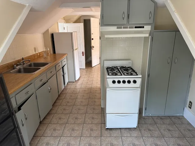 a kitchen with a stove top oven and cabinets