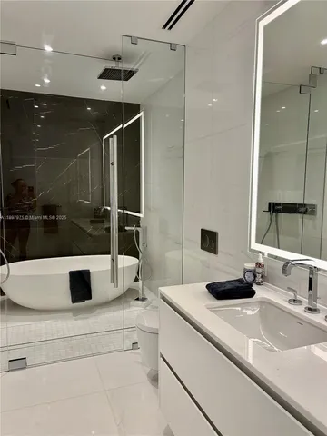 a bathroom with a double vanity sink and mirror