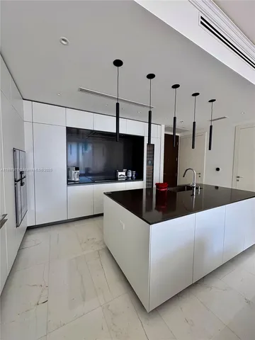 a kitchen with stainless steel appliances a refrigerator and a sink