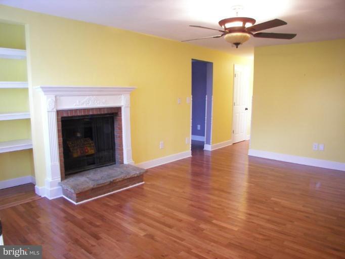 6790 Winchester Grade Road Berkeley Springs, WV 25411 - Photo 3 of 13 Fireplace, built-in book shelves Hardwood Floors