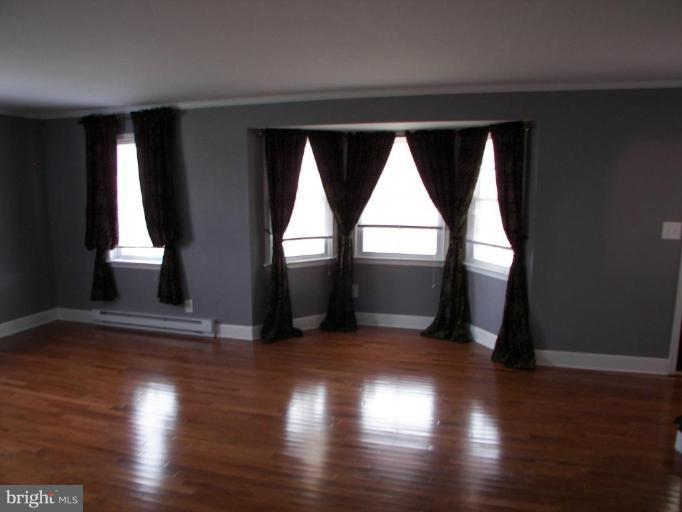 6790 Winchester Grade Road Berkeley Springs, WV 25411 - Photo 5 of 13 Bow Window in Living Brings in Lots of light.