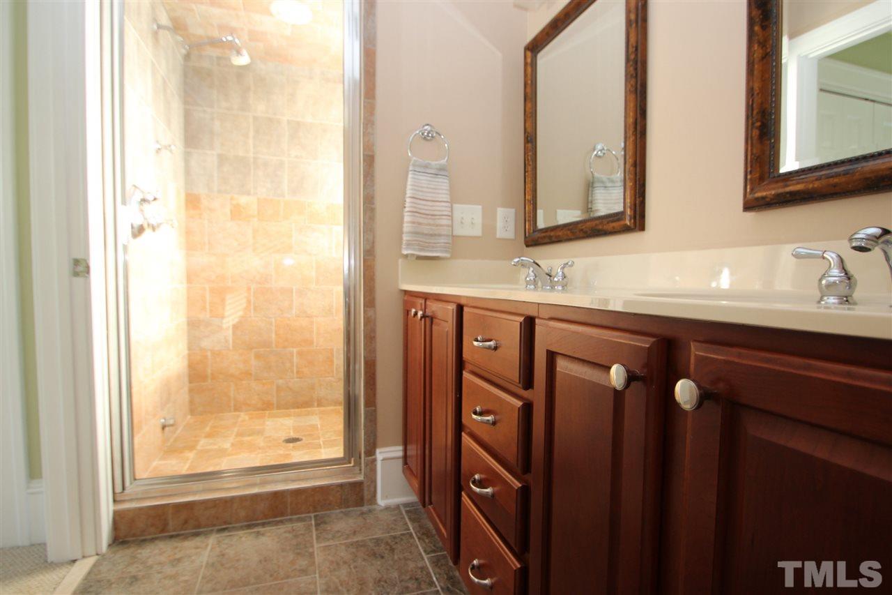 1827 White Oak Road Raleigh, NC 27608 - Photo 14 of 25 a bathroom with a double vanity sink and a mirror