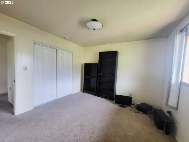 a view of an empty room with closet