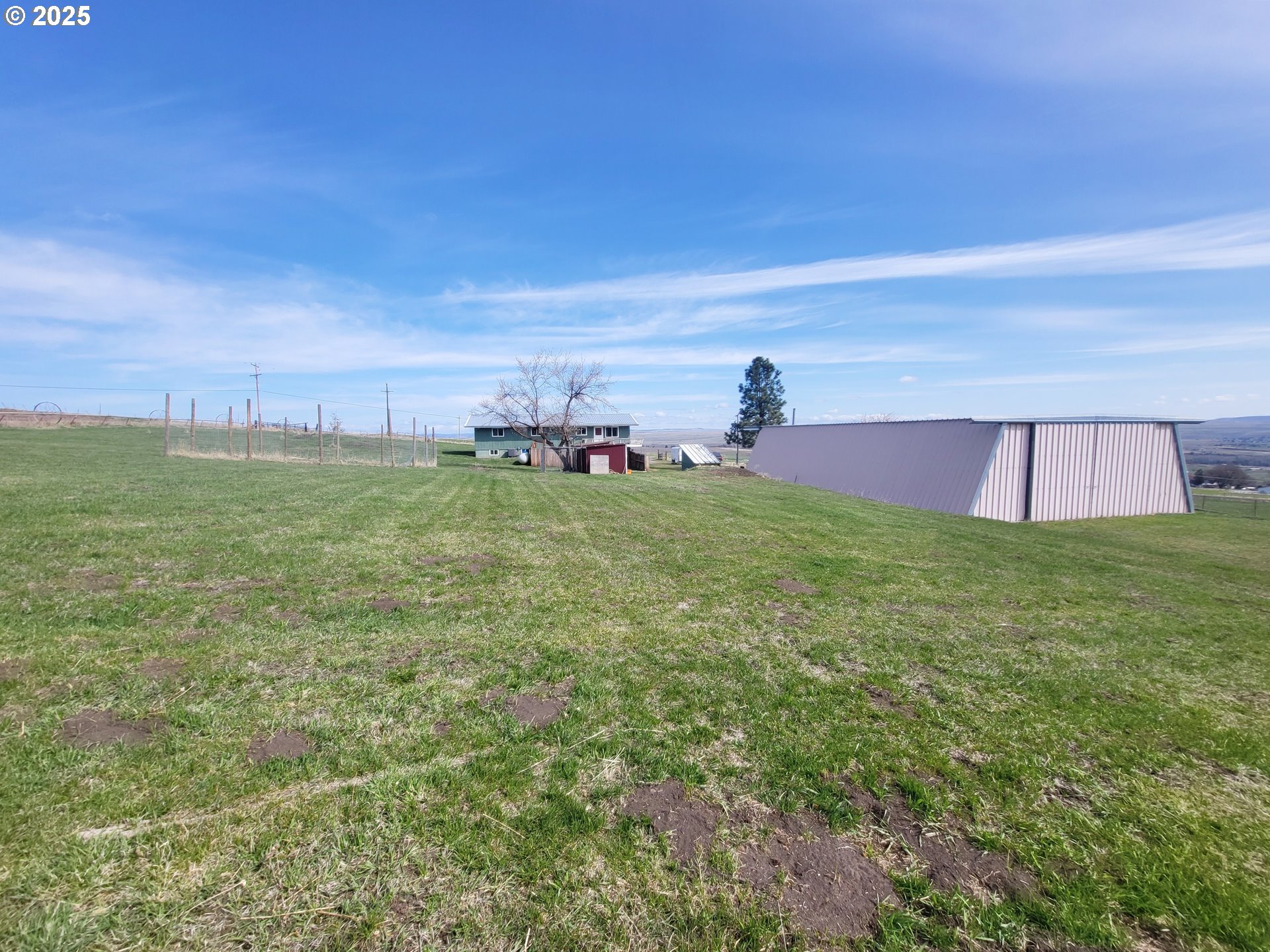 81202 Reavis Lane Enterprise, OR 97828 - Photo 9 of 44 a view of a field with grass and a bench