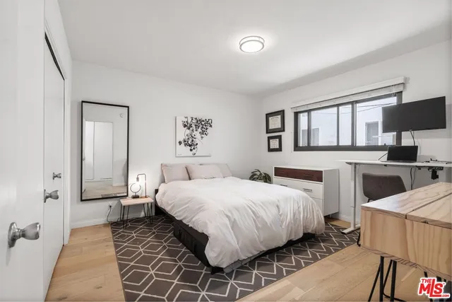 a bedroom with a bed and a couch