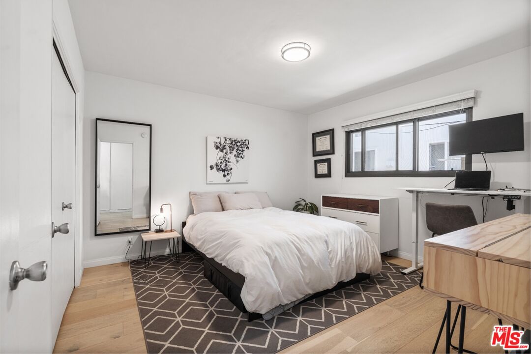 a bedroom with a bed and a couch