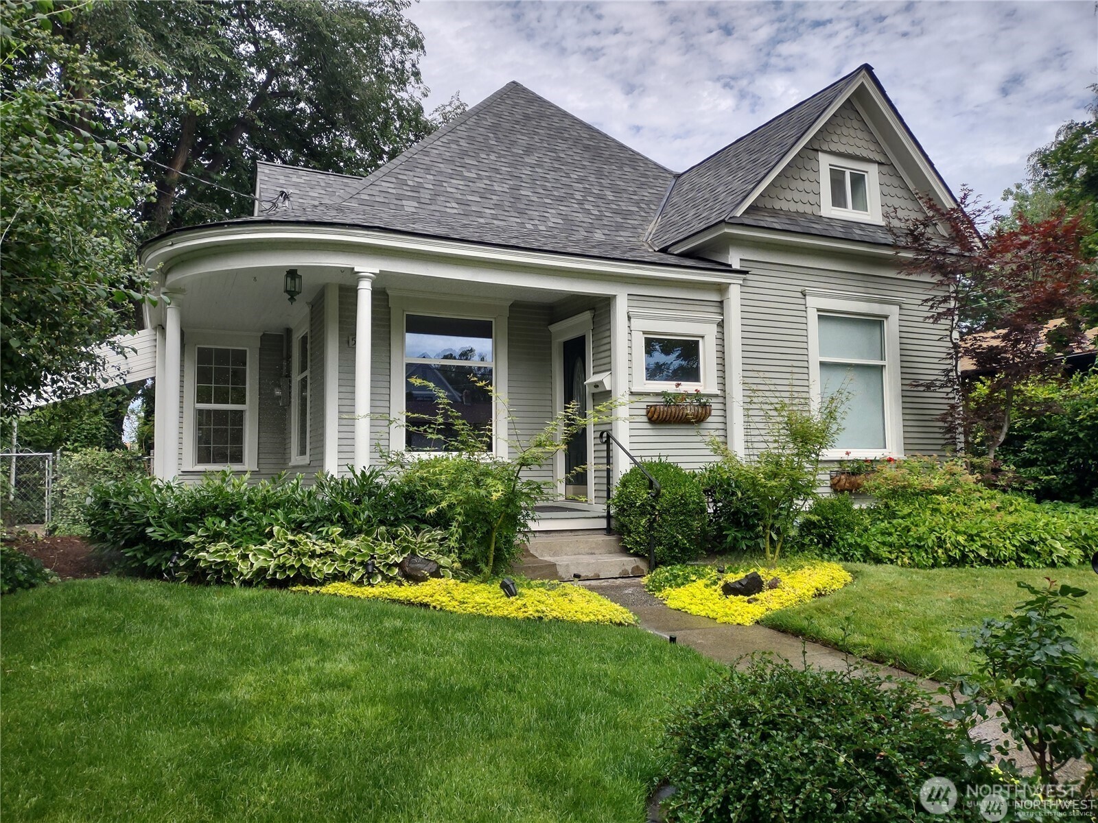 a front view of a house with garden