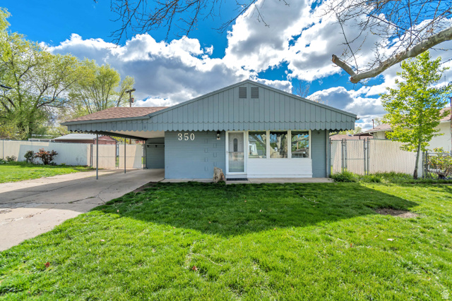350 Church Street Layton, UT 84041 - Photo 1 of 1 Single story home featuring an attached carport, driveway, concrete block siding, a gate, and a porch
