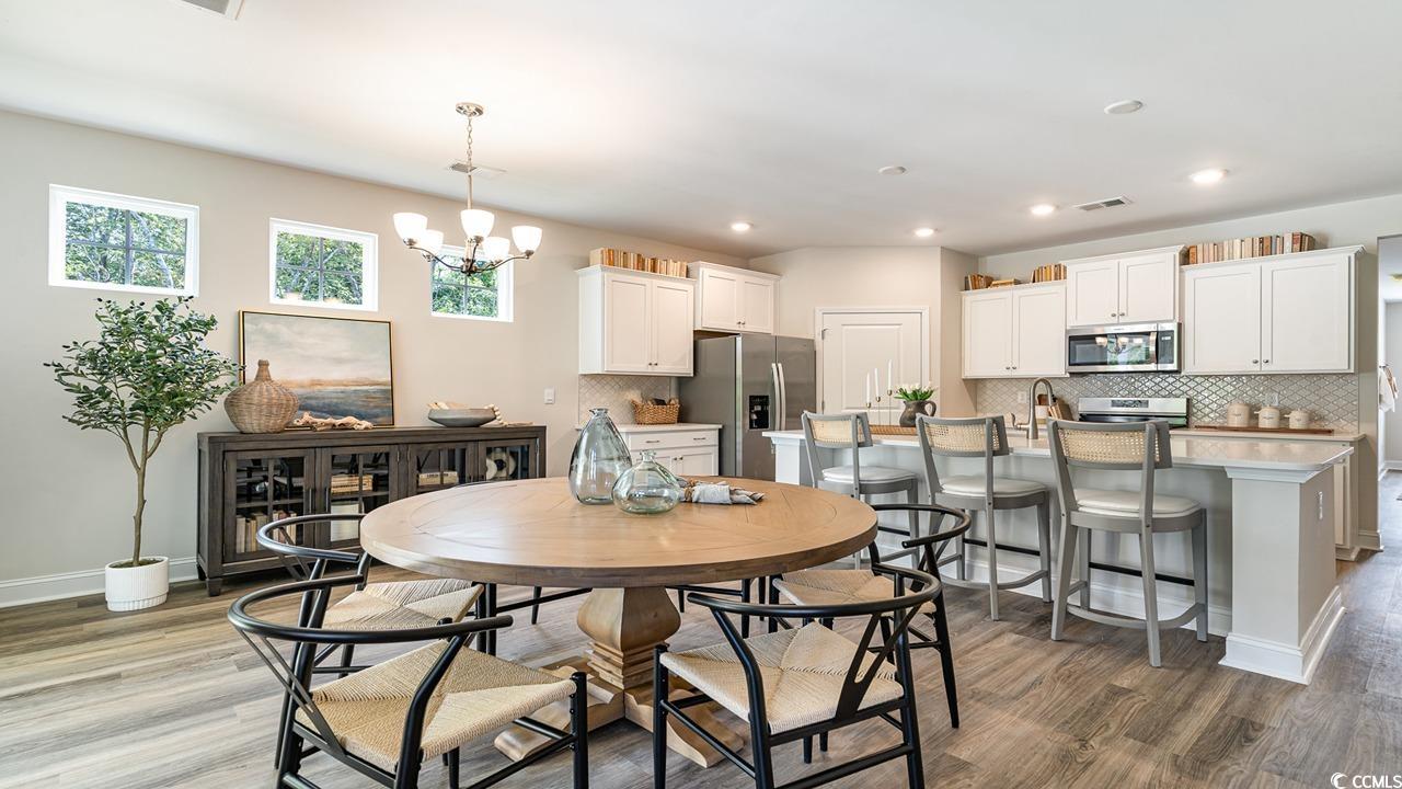 112 Fair Meadow Loris, SC 29569 - Photo 15 of 23 Dining area with a notable chandelier and wood-typ