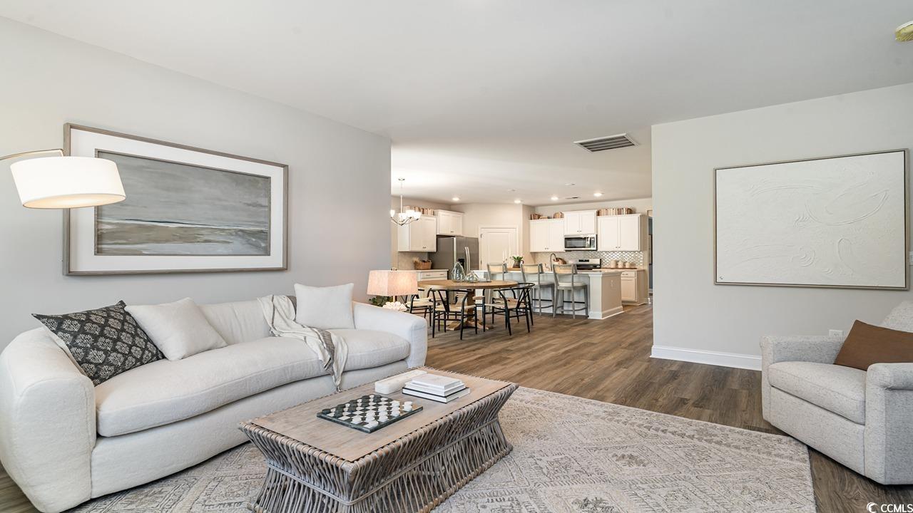 112 Fair Meadow Loris, SC 29569 - Photo 18 of 23 Living room with a notable chandelier and dark har