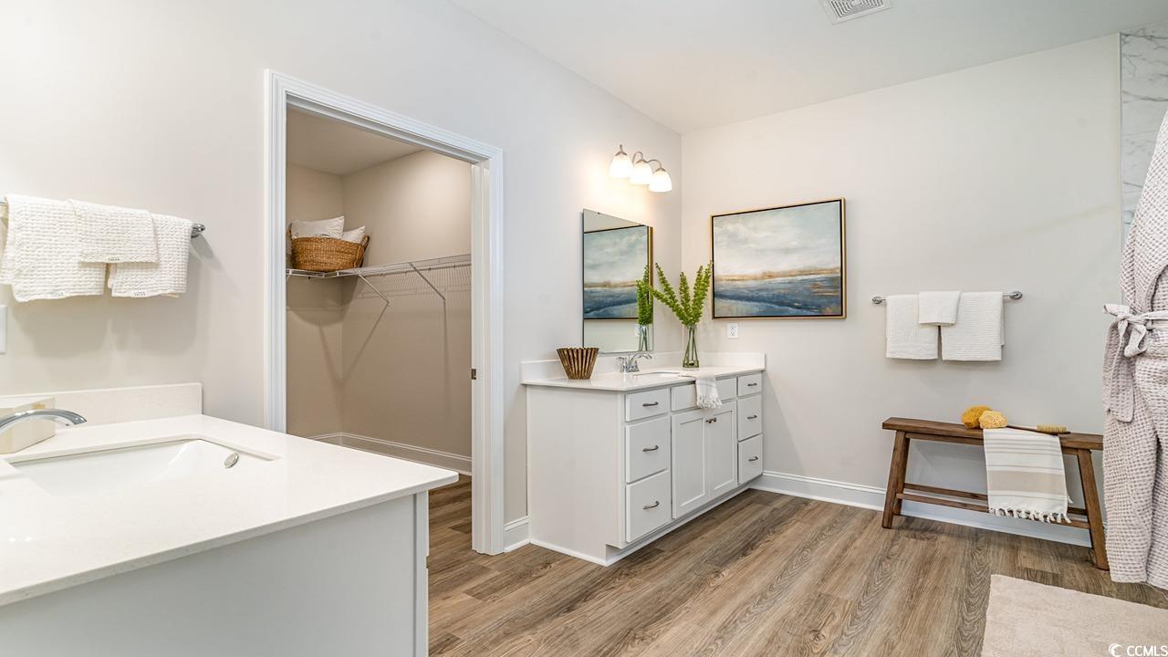 112 Fair Meadow Loris, SC 29569 - Photo 21 of 23 Bathroom featuring double vanity and hardwood / wo