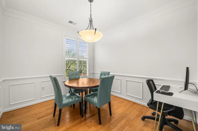 a view of a dining room with a table and chairs