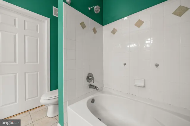 a white bath tub sitting next to a white toilet