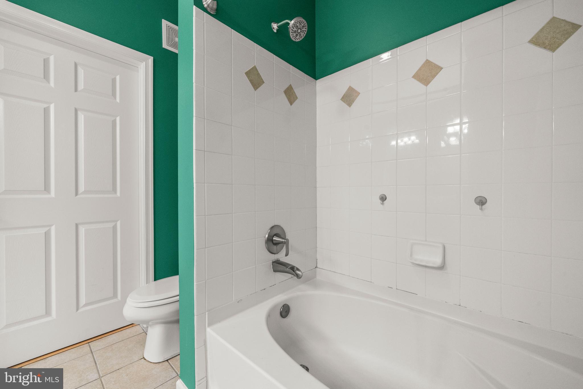 8 Granite Place, Unit 266 Gaithersburg, MD 20878 - Photo 18 of 36 a white bath tub sitting next to a white toilet