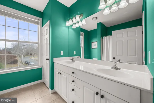 a bathroom with a sink mirror and a bathtub